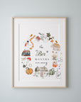 The Ber Months Are Coming print shown in a light oak frame with a white mount on a pale grey blue wall, the watercolour wreath of autumn and winter things sitting inside the mount window. Frame not included.